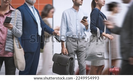 Quick thief pickpocketing in the crowded city street, he is stealing a wallet from a man's pocket Royalty-Free Stock Photo #2249954993