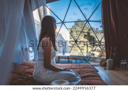Travel vacation glamping concept, Happy traveler asian woman relax inside a luxury camping dome tent in Mon Jam, Chiang Mai, Thailand Royalty-Free Stock Photo #2249956377
