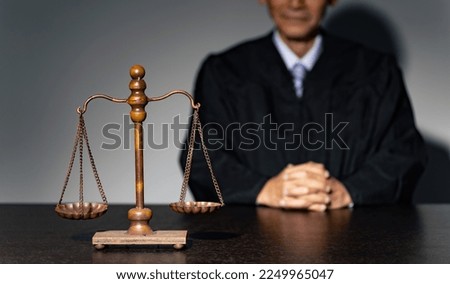 A man in a robe and a scale. The concept of judiciary. Royalty-Free Stock Photo #2249965047