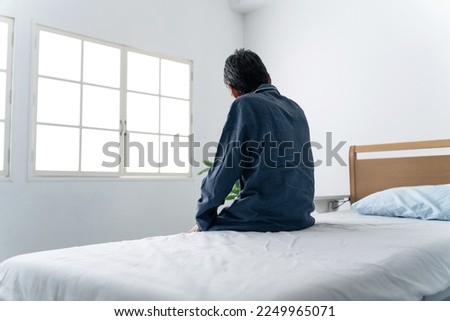 Inpatient who is absentminded in the hospital room. Royalty-Free Stock Photo #2249965071