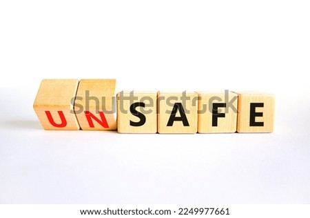 Safe or unsafe symbol. Concept word Safe Unsafe on wooden cubes. Beautiful white table white background. Business safe or unsafe concept. Copy space.