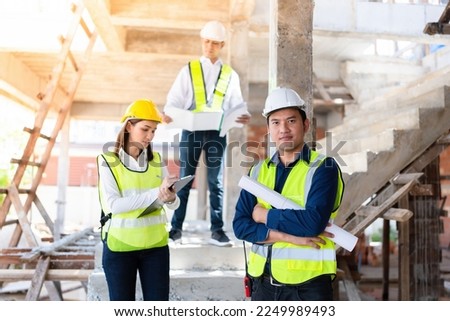 Photo of a group of smart engineers. Have the knowledge and confidence to work and power, standing on the construction site. The back has an architectural structure of the industry