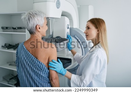 Senior woman having mammography scan at hospital with medical technician. Mammography procedure, breast cancer prevention Royalty-Free Stock Photo #2249990349