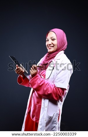 Confident female nurse. Confident Muslim female doctor standing over isolated white background. Closeup portrait of friendly, smiling confident Muslim female doctor.