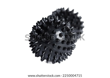 Black double or peanut spiky ball massager for yoga pilates or stretching and fascia pain. Sports equipment for fitness isolated on a white background. Concept of sports massage.