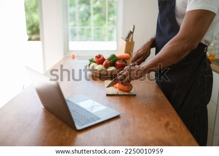Portrait of asian man making salad at home. cooking food and Lifestyle moment