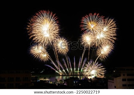 Colorful fireworks on the sea, city foreground, long explosed image.