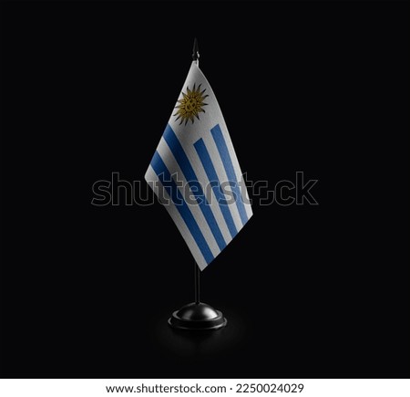 Small national flag of the Uruguay on a black background.