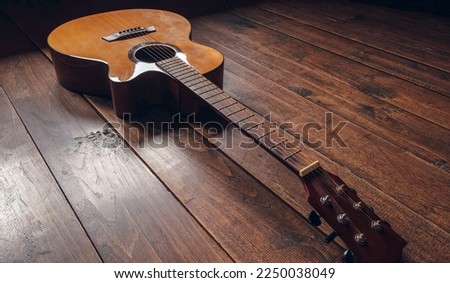 Top view of classical guitar on old wooden background.dark tone