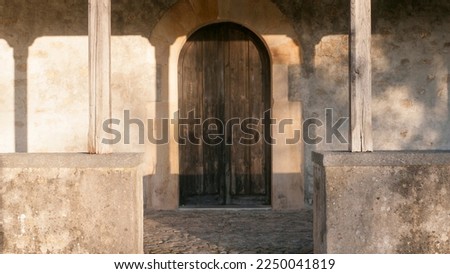 Arched wooden door in ancient church in Asturias