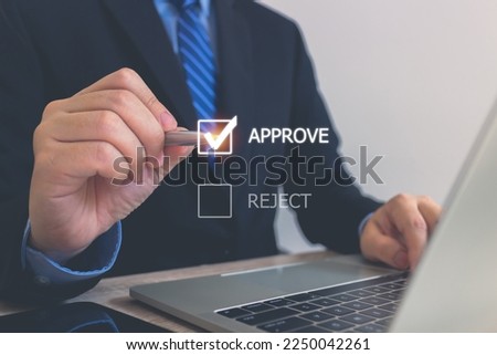 Businessman writing or tick correct mark to approve document icon and project concept.Quality management with Quality Assurance or QA and Quality Control or QC and improvement. Royalty-Free Stock Photo #2250042261