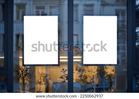 Blank window poster template. Promotional banner on the store, office window mock up. Blurred background, selective focus, copy space