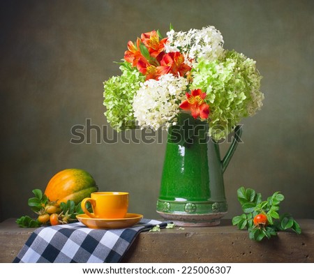 Still life with flowers and a yellow cup