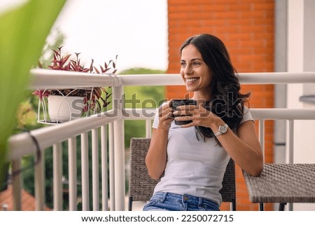 beautiful young woman relaxing over a cup of tea Royalty-Free Stock Photo #2250072715