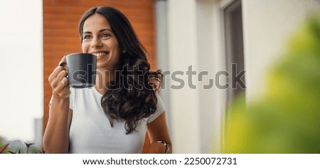 beautiful young woman relaxing over a cup of tea Royalty-Free Stock Photo #2250072731