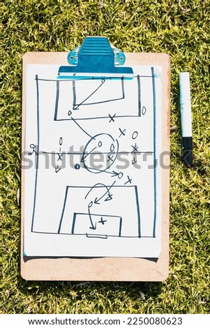 Sports, soccer field and clipboard planning a strategy for a group mission, target or tactics for goals. Solutions, teamwork and coach drawing winning tactics or ideas on grass in a football stadium Royalty-Free Stock Photo #2250080623