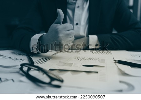 Close up of young business man and digital number of stock market background to represent successful in investment marketing. Find out the best solution in business and financial as concept.