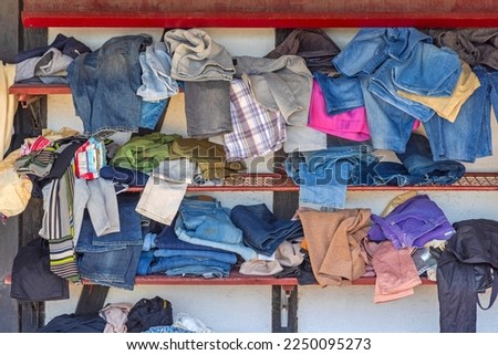 Messy Wardrobe Closet Shelf With Pants Denim Chaos Royalty-Free Stock Photo #2250095273