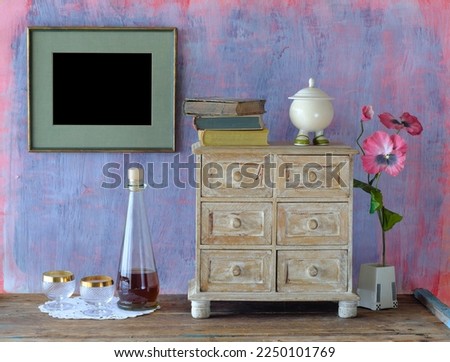 shabby chic living room design. View of modern style interior with books 
and small chest of drawers and empty picture frame, home staying, reading and minimalism concept Royalty-Free Stock Photo #2250101769