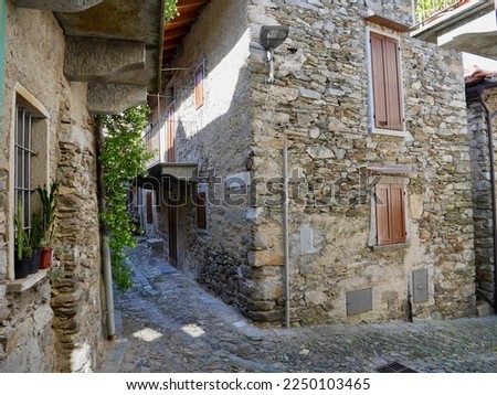 Narrow street with typical stone houses in Cavandone, Piedmont, Italy. High quality photo