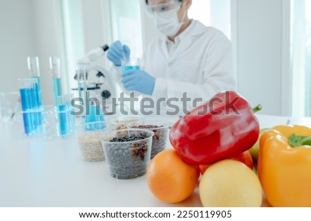 Scientist check chemical food residues in laboratory. Control experts inspect quality of fruits, vegetables. lab, hazards, ROHs, find prohibited substances, contaminate, Microscope, Microbiologist Royalty-Free Stock Photo #2250119905