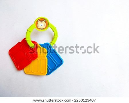 Close up of cute and colorfull rattle. Babys toy. Isolated white background. Space for text
