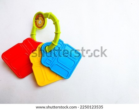 Close up of cute and colorfull rattle. Babys toy. Isolated white background. Space for text