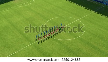 Aerial Top View Shot of Soccer Championship Match Beginning: Two Professional Football Teams Enter Stadium Field Where they Will Compete for the Champion Status. Start of the Major League Tournament