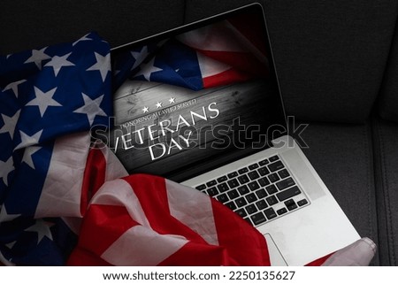 laptop with usa flag and inscription veterans day