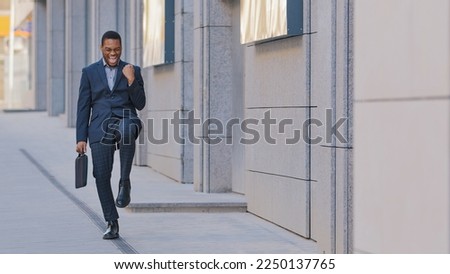 Happy success African American man candidate hired has job offer ethnic worker manager intern businessman winner outdoors feel excited yes gesture celebrating professional triumph victory opportunity Royalty-Free Stock Photo #2250137765
