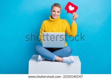 Photo of adorable pretty lady blogger sitting podium raise red card share instagram facebook post repost isolated on blue color background Royalty-Free Stock Photo #2250140147