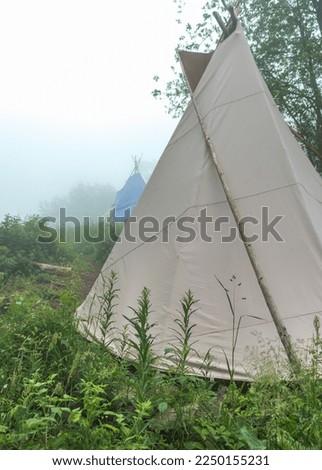 wigwam of beige color in a clearing in the Carpathian mountains, summer vacation, ethnic housing