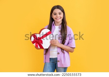 glad teen girl with birthday gift on background. photo of teen girl with birthday gift box.