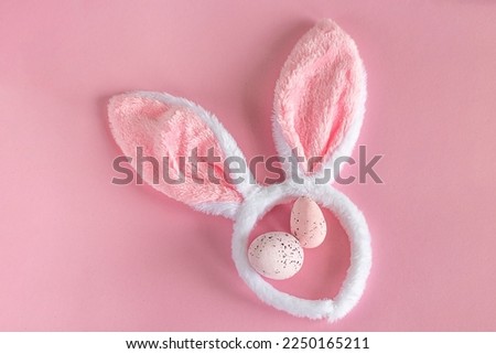 Easter background. Pink Easter bunny ears on a pink background. Easter eggs. Easter. copy space