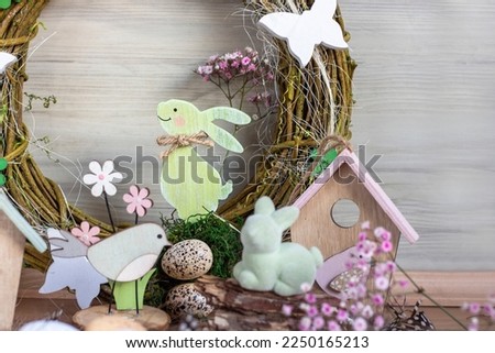 Easter background with Easter wreath and colored Easter eggs and blooming flowers. Easter composition.