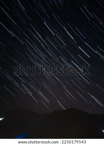Arc motion of the stars on top of the mountain