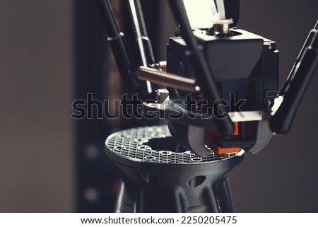 FDM-3D-printer with delta kinematic layout makes a flange part with internal structure from silver grey material. view on print head and infill structure. futuristic additive manufacturing concept
 Royalty-Free Stock Photo #2250205475