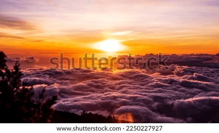 The top of Haleakala National Park (East Maui Volcano) in Maui, Hawaii, pictured above the clouds at sunset. Royalty-Free Stock Photo #2250227927