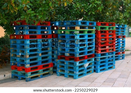 Bunch of colourful wooden pallets. Stacks of pallets.