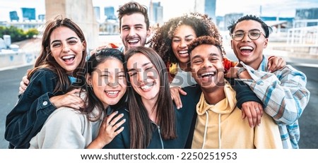 Happy group of young people smiling at camera outdoors - Smiling friends having fun hanging out on city street - University students standing together in college campus - Friendship and youth concept