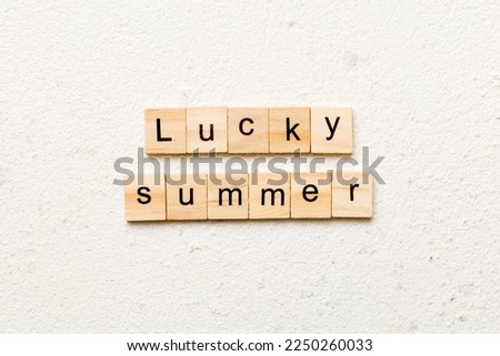 lucky Summer word written on wood block. lucky Summer text on cement table for your desing, concept.