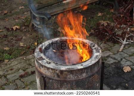A fire pit made out of a washing machine tumbler. High quality photo