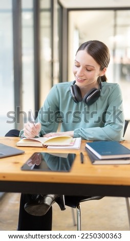 Woman enjoying listening to music wearing headphones, read book