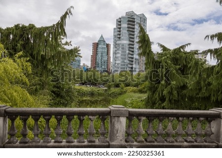 view of the city from the park. Beautiful nature, bridge and skyscrapers on cloudy sky background