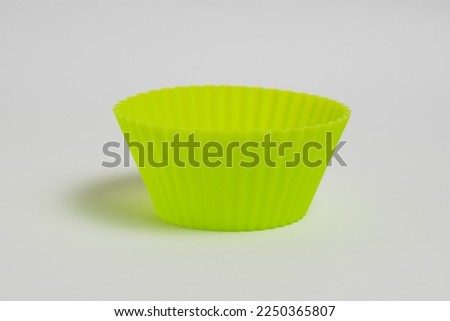 Yellow silicone cake mold on a white background.