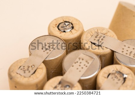 Environment Ideas. Closeup of Bundle of Soldered Ni-Mh Rechargeable Batteries  Placed Together Over Beige.Horizontal image Orientation Royalty-Free Stock Photo #2250384721