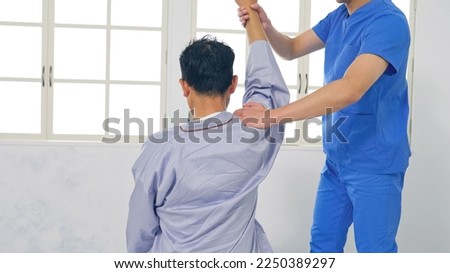 A physiotherapist who performs rehabilitation. Massage. Royalty-Free Stock Photo #2250389297
