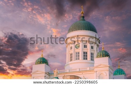 Helsinki, Finland. Close Up Of Lutheran Cathedral On Senate Square. Famous Landmark In Finnish Capital. Very Peri Sky Above Cathedral. Bright Dramatic Light Purple Sky.