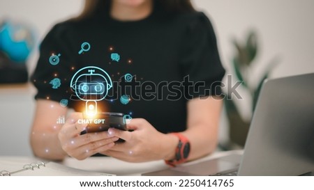 ChatGPT Chat with AI or Artificial Intelligence. woman chatting with a smart AI or artificial intelligence using an artificial intelligence chatbot developed by OpenAI. Royalty-Free Stock Photo #2250414765