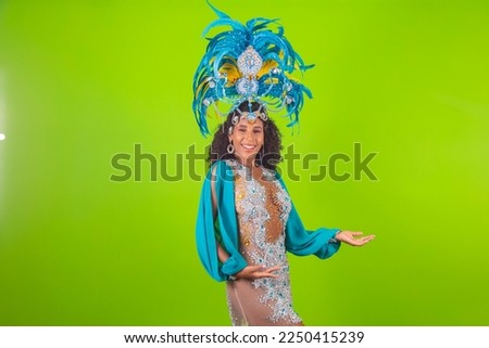 Brazilian afro woman posing in samba costume over green background with free space 
